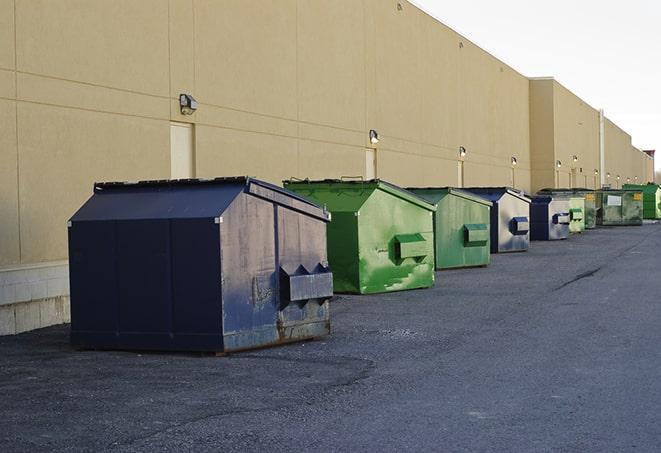 a row of construction dumpsters parked on a jobsite in Big Bend, WI